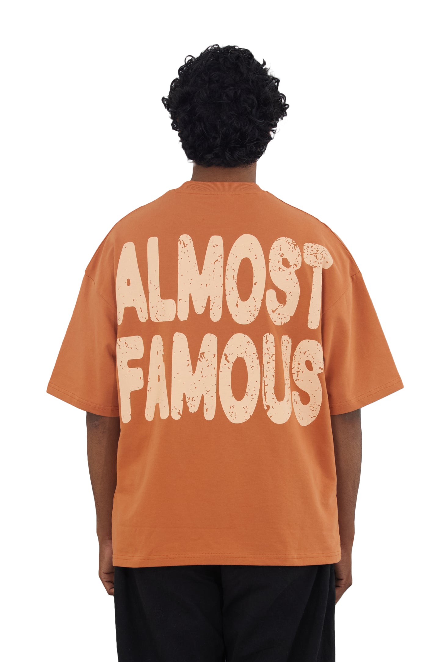 The Famous Tee by Fekki is a vibrant orange t-shirt that proudly proclaims, "Almost Famous." This playful and eye-catching design speaks to those who embrace their unique journey and celebrate individuality. Made from 100% cotton, this tee offers exceptional comfort and durability, making it perfect for casual outings or making a bold statement. The bright orange color adds a lively pop to any outfit, ensuring you stand out from the crowd. As a limited-edition piece, the Famous Tee is a must-have for fashio