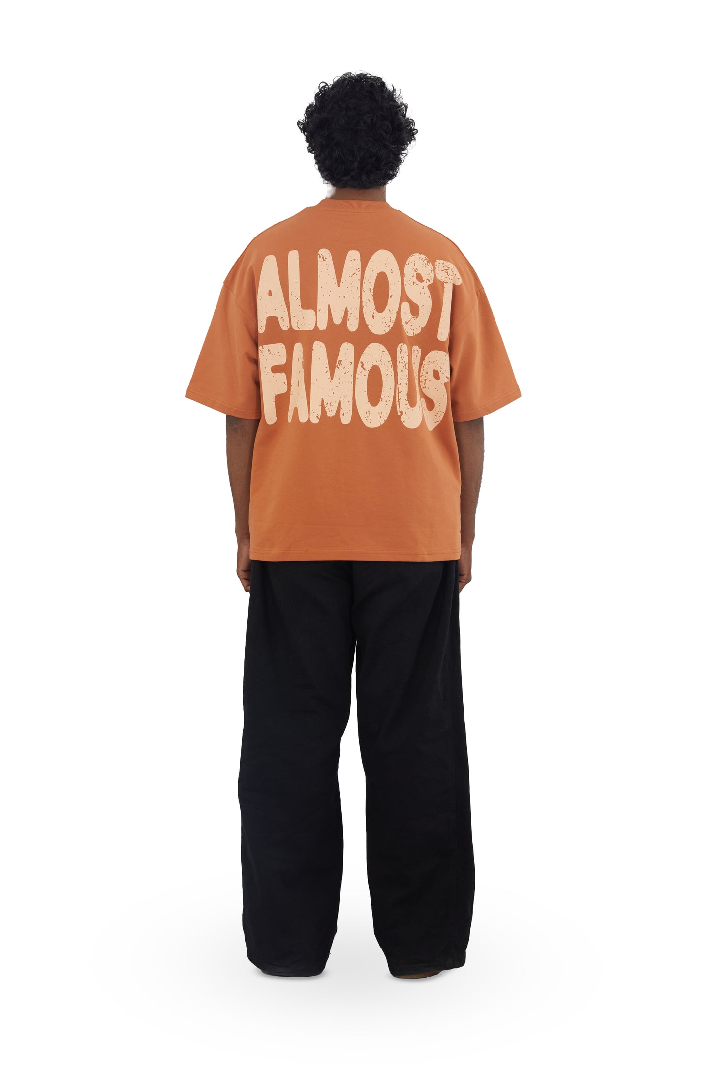 The Famous Tee by Fekki is a vibrant orange t-shirt that proudly proclaims, "Almost Famous." This playful and eye-catching design speaks to those who embrace their unique journey and celebrate individuality. Made from 100% cotton, this tee offers exceptional comfort and durability, making it perfect for casual outings or making a bold statement. The bright orange color adds a lively pop to any outfit, ensuring you stand out from the crowd. As a limited-edition piece, the Famous Tee is a must-have for fashio